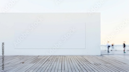 Coastal Scene with Blurred Pedestrians Passing by a Blank Wall Banner on a Wooden Floor at Daytime, Creating a Modern Minimalist Ambiance for Mockup Space
