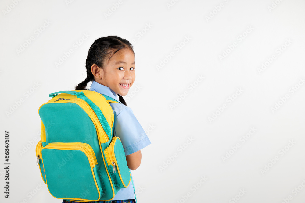 Portrait Back Asian smiling young girl kids kindergarten holding a green and yellow backpack studio shot isolated white background, happy cute little schoolgirl wears school uniform, back to school Portrait Back Asian smiling young girl kids kindergarten holding a green and yellow backpack studio shot isolated white background, happy cute little schoolgirl wears school uniform, back to school