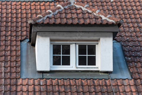 Canvas Print Closed dormer window on a roof with red tiles