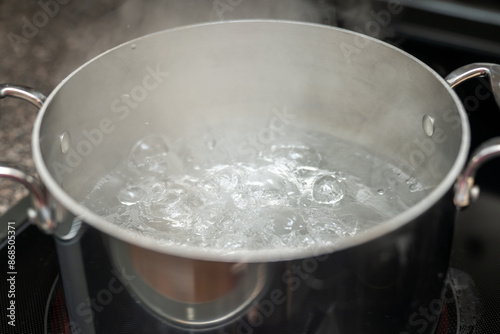 Boiling pot of water, metal pot with water ready for pasta