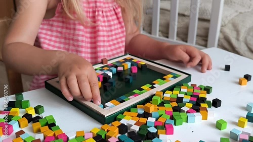 little girl play wooden blocks constructor, wooden mosaic