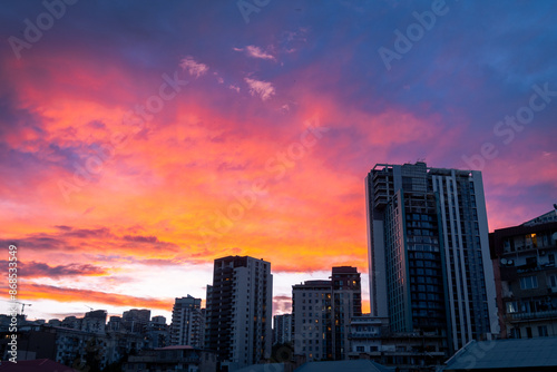 Aerial sky view real estate building facades in Tbilisi, Georgia capital on sunset. Property big city development and high rise buildings. Beautiful Tbilisi sunset banner concept.