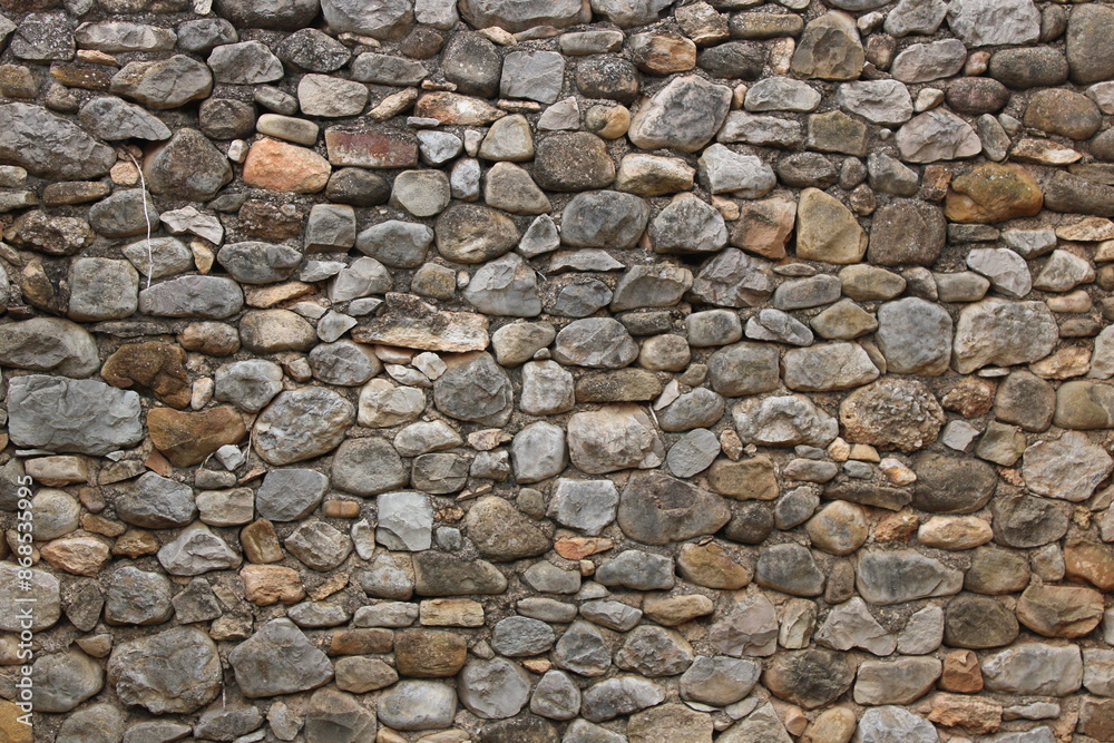Stone wall in an old abandoned and ruined house