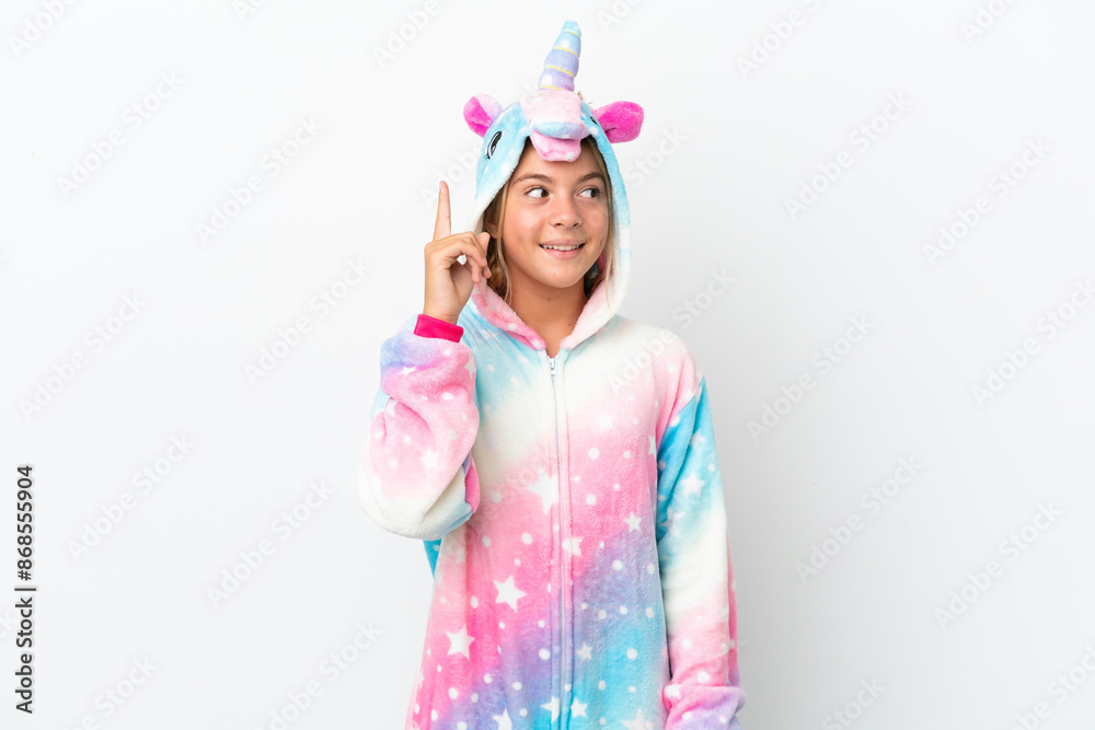 Little girl with unicorn pajamas isolated on white background intending to realizes the solution while lifting a finger up Little girl with unicorn pajamas isolated on white background intending to realizes the solution while lifting a finger up