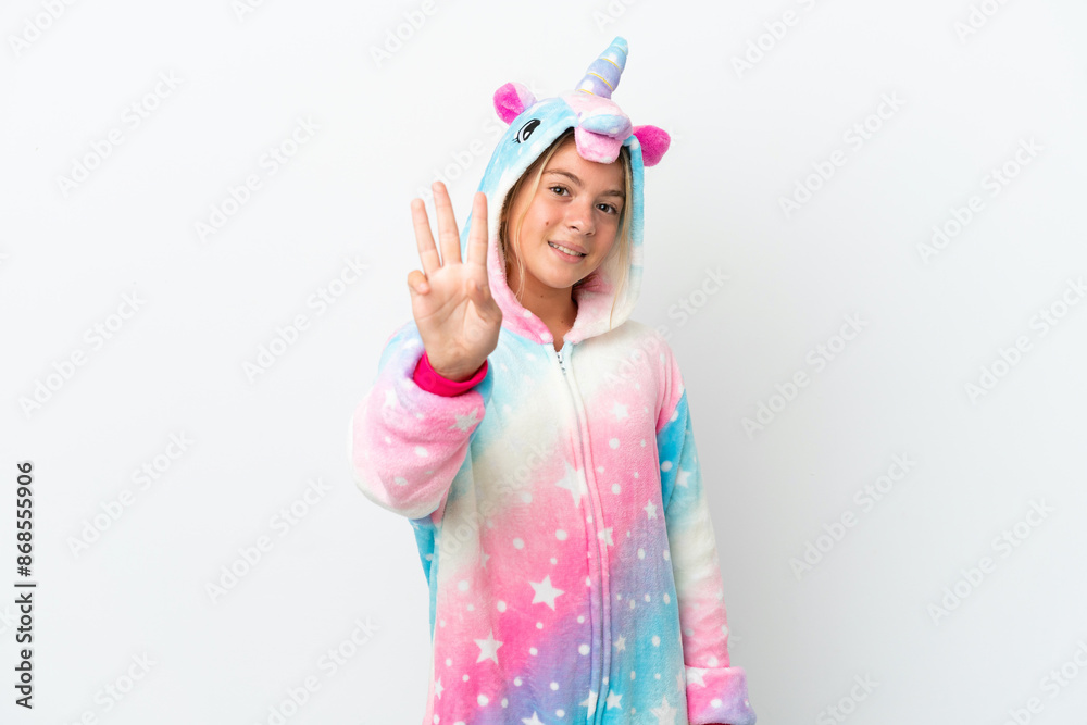 Little girl with unicorn pajamas isolated on white background happy and counting three with fingers Little girl with unicorn pajamas isolated on white background happy and counting three with fingers