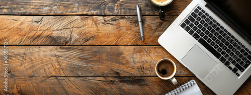 Top view flat lay photo banner mockup of office working desk with laptop computer note book and pens with space for text editing in rustic wooden table top background
