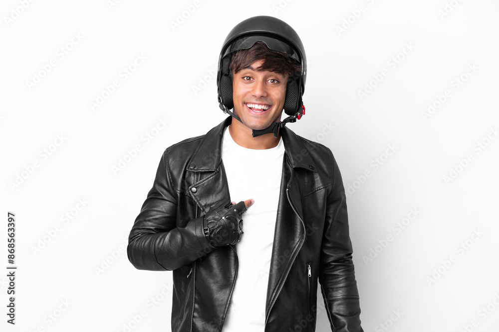 Young man with a motorcycle helmet isolated on white background with surprise facial expression Young man with a motorcycle helmet isolated on white background with surprise facial expression