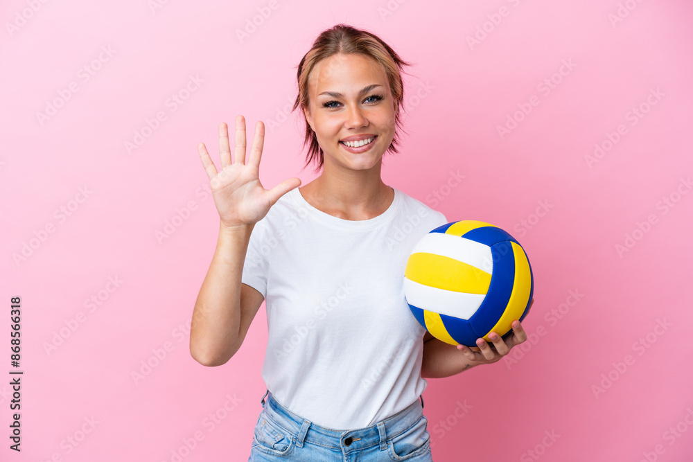 Young Russian woman playing volleyball isolated on pink background counting five with fingers Young Russian woman playing volleyball isolated on pink background counting five with fingers