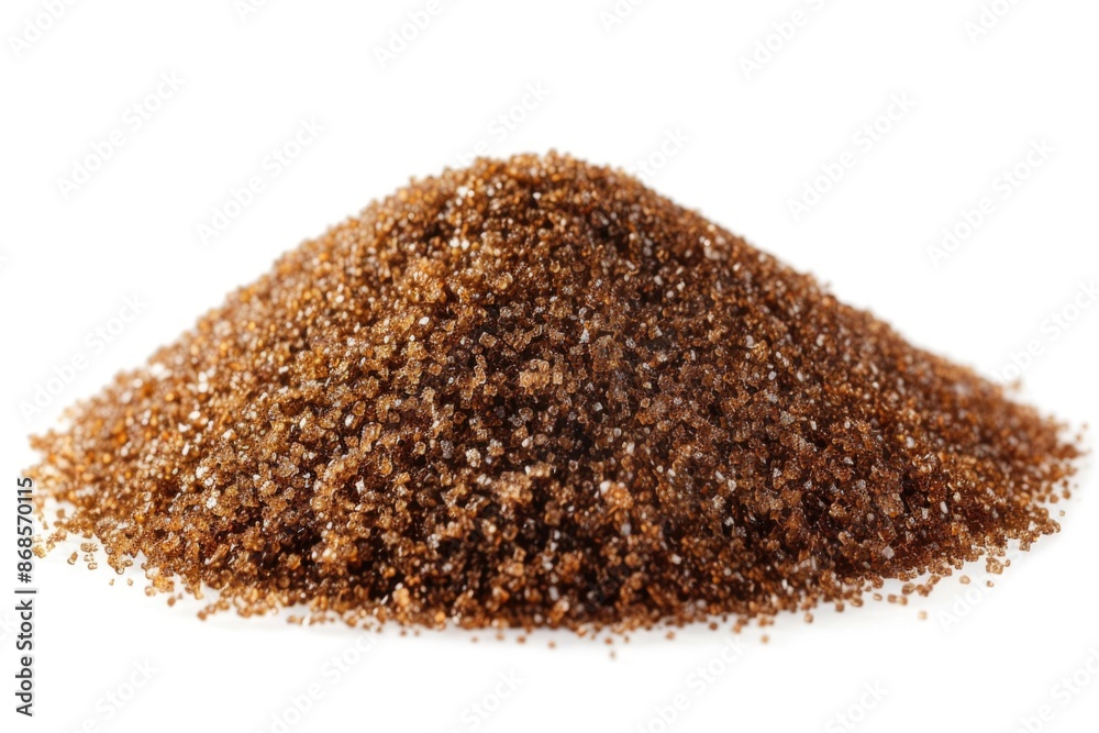 A pile of brown sugar sits on a white surface, ready for use or decoration A pile of brown sugar sits on a white surface, ready for use or decoration