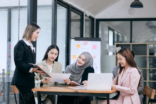 Professional team at and both male and female members participated in a lively brainstorming session at the company office. They collaborate on creative projects using modern technology.