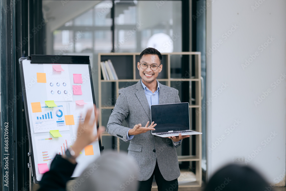 Fototapeta premium Professional team at and both male and female members participated in a lively brainstorming session at the company office. They collaborate on creative projects using modern technology.