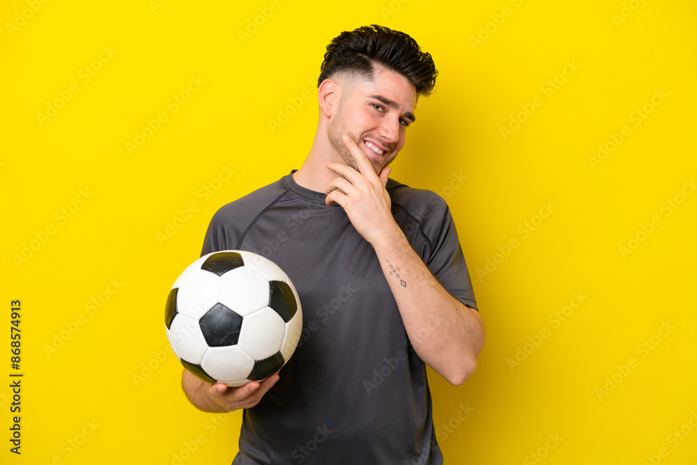 Handsome young football player man isolated on yellow background happy and smiling Handsome young football player man isolated on yellow background happy and smiling