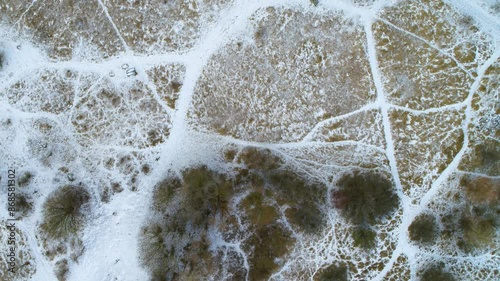 Drone moving slowly forwards over marshland in winter time photo