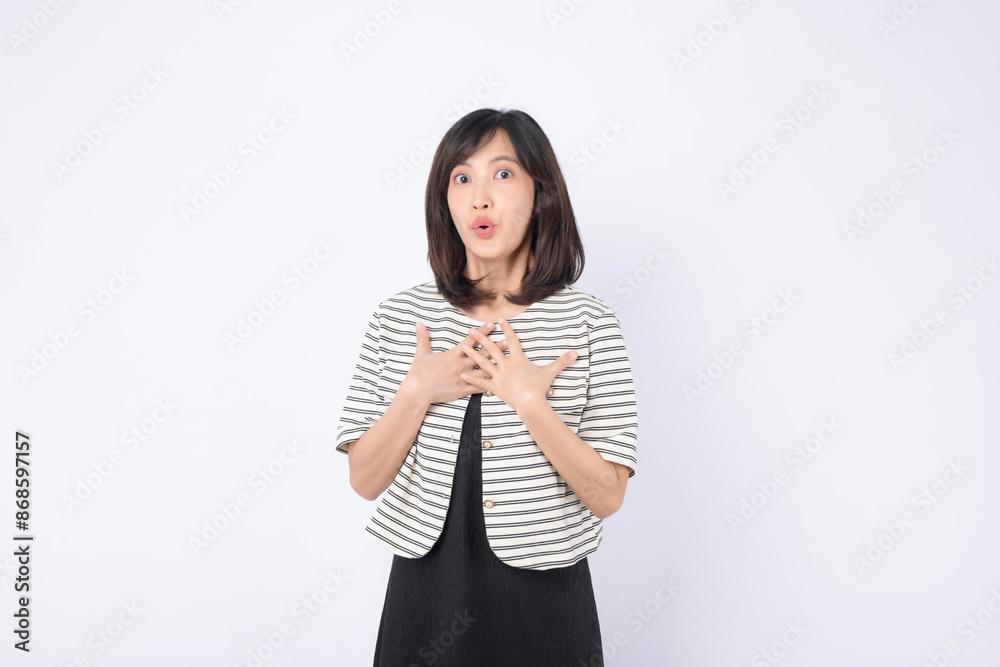 Asian woman is posing with a surprised expression in a white studio background. Asian woman is posing with a surprised expression in a white studio background.