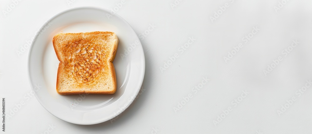 A slice of toast is on a white plate A slice of toast is on a white plate