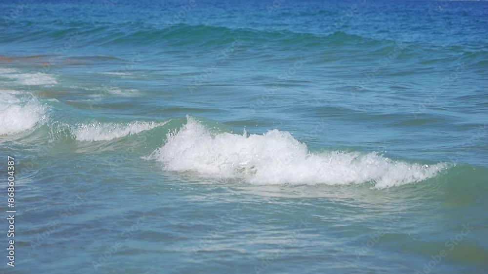 Waves gently rolling onto the sandy beach in slow motion in slow motion 300fps Waves gently rolling onto the sandy beach in slow motion in slow motion 300fps