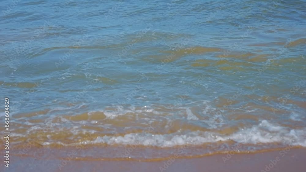 Waves gently rolling onto the sandy beach in slow motion in slow motion 300fps Waves gently rolling onto the sandy beach in slow motion in slow motion 300fps