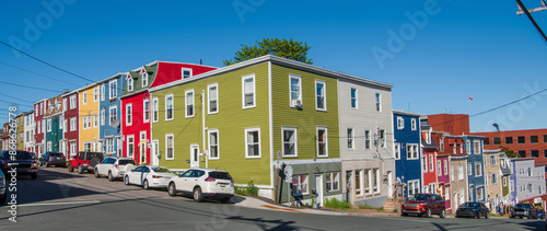The vibrant, rainbow-colored row houses of St. John's, known as Jelly Bean Row, extend beyond a single street. They are a prominent feature of the densely built downtown area, stretching down to the h