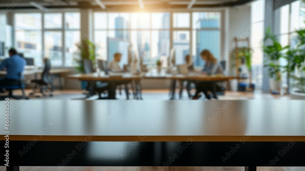Empty desk in modern office. Blurred background image of a modern office space with empty desk in the foreground. Ideal for product placement or website banners. Empty desk in modern office. Blurred background image of a modern office space with empty desk in the foreground. Ideal for product placement or website banners.