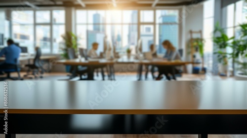 Empty desk in modern office. Blurred background image of a modern office space with empty desk in the foreground. Ideal for product placement or website banners.