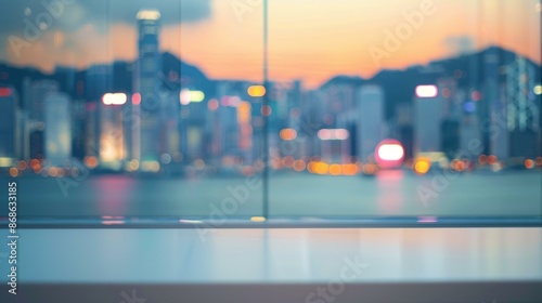 Blurred cityscape at sunset with empty space. Serene blurred cityscape view through window with empty space in the foreground, perfect for product placement or background use.