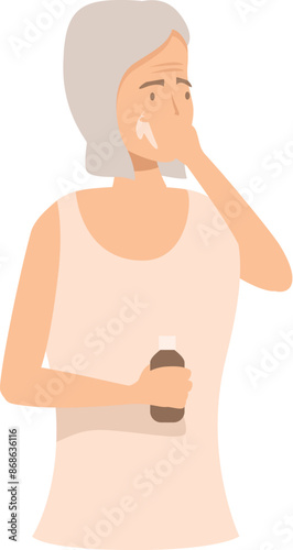 Senior woman applying anti aging cream on her face, taking care of her skin