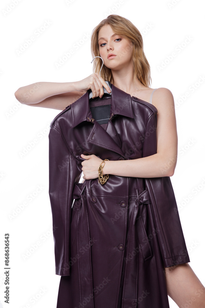 High fashion photo of a beautiful elegant young woman in pretty long purple lilac leather jacket, coat posing on white background. Slim figure. Blonde High fashion photo of a beautiful elegant young woman in pretty long purple lilac leather jacket, coat posing on white background. Slim figure. Blonde