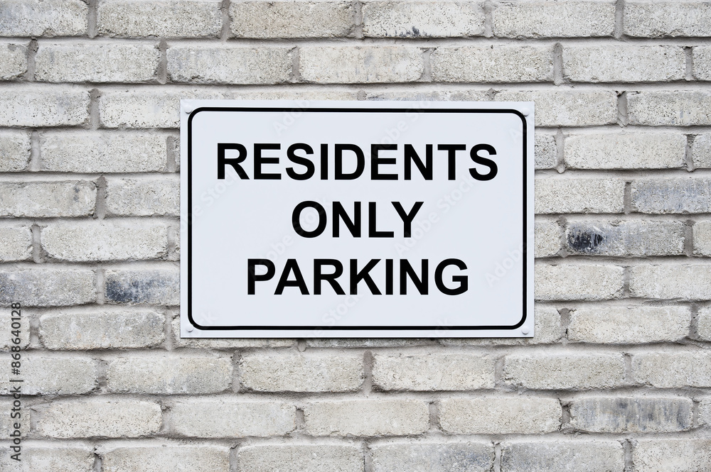 Residents only parking sign on wall at private housing development Residents only parking sign on wall at private housing development