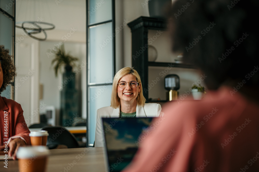 Company owner on a meeting with two of her employees in her office Company owner on a meeting with two of her employees in her office