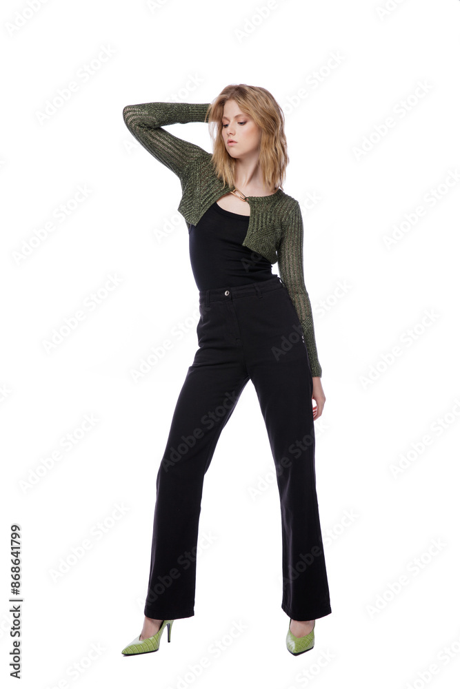 High fashion photo of a beautiful elegant young woman in pretty black denim pants, trousers, top, green short jacket posing on white background. Slim figure. Blonde High fashion photo of a beautiful elegant young woman in pretty black denim pants, trousers, top, green short jacket posing on white background. Slim figure. Blonde