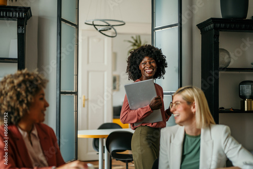 Company owner on a meeting with two of her employees in her office