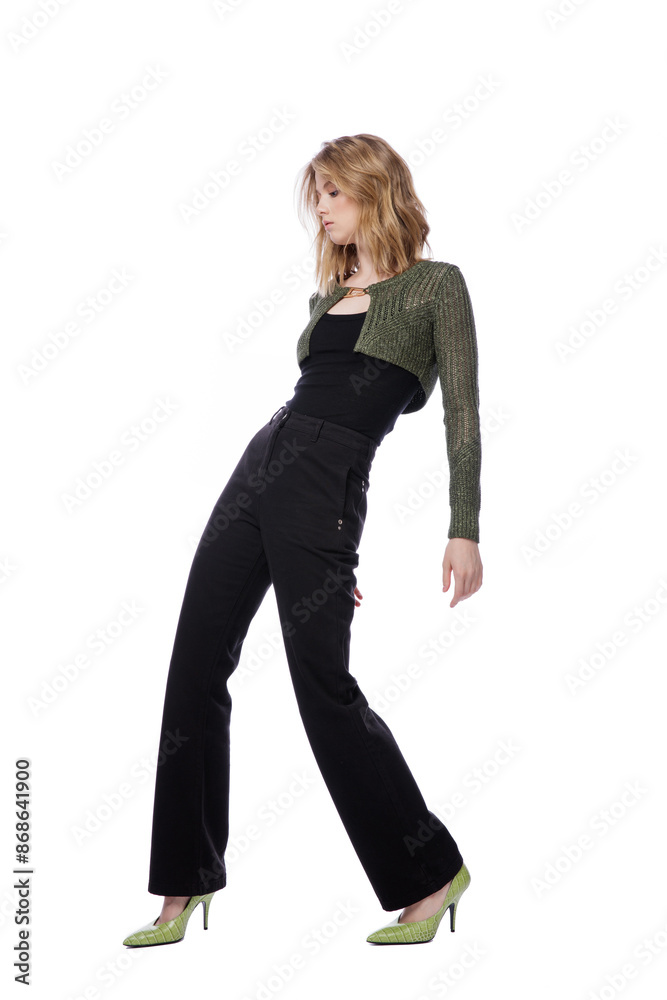 High fashion photo of a beautiful elegant young woman in pretty black denim pants, trousers, top, green short jacket posing on white background. Slim figure. Blonde High fashion photo of a beautiful elegant young woman in pretty black denim pants, trousers, top, green short jacket posing on white background. Slim figure. Blonde