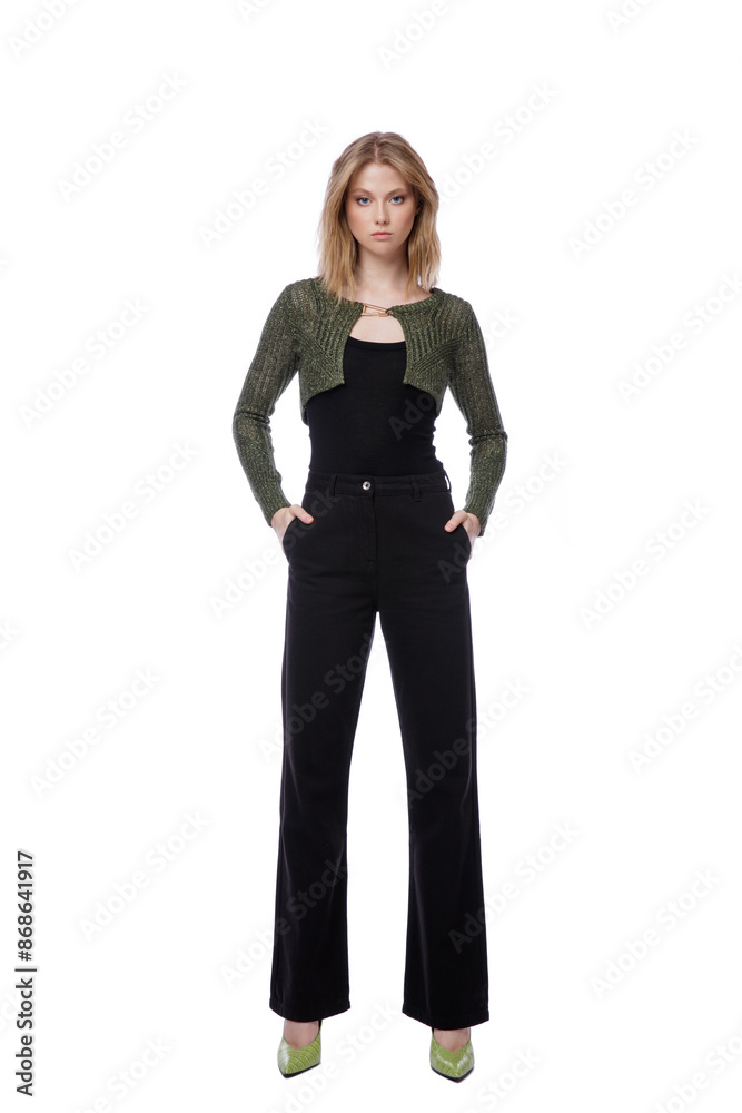 High fashion photo of a beautiful elegant young woman in pretty black denim pants, trousers, top, green short jacket posing on white background. Slim figure. Blonde High fashion photo of a beautiful elegant young woman in pretty black denim pants, trousers, top, green short jacket posing on white background. Slim figure. Blonde