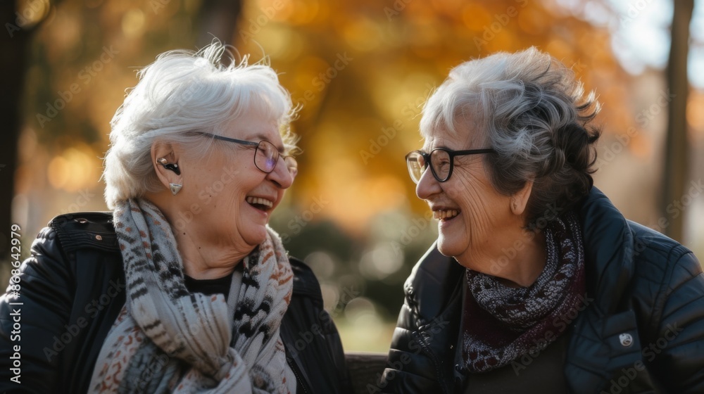 Senior women bonding and enjoying their retirement together on a sunny park bench sharing laughter and warm conversation Senior women bonding and enjoying their retirement together on a sunny park bench sharing laughter and warm conversation