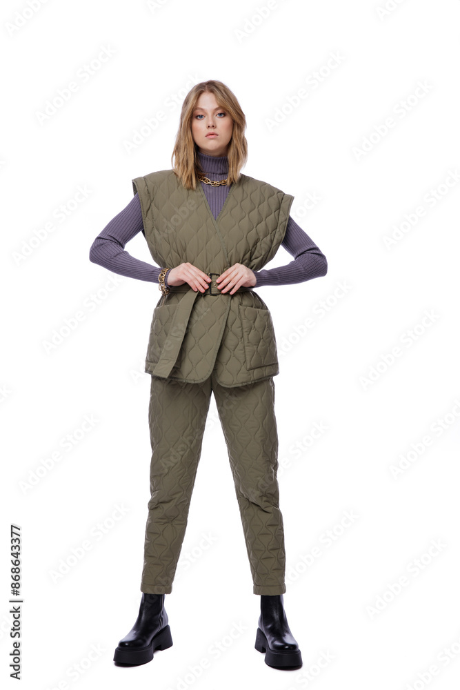 High fashion photo of a beautiful elegant young woman in pretty green pants, trousers, purple blouse, jacket posing on white background. Slim figure. Blonde High fashion photo of a beautiful elegant young woman in pretty green pants, trousers, purple blouse, jacket posing on white background. Slim figure. Blonde