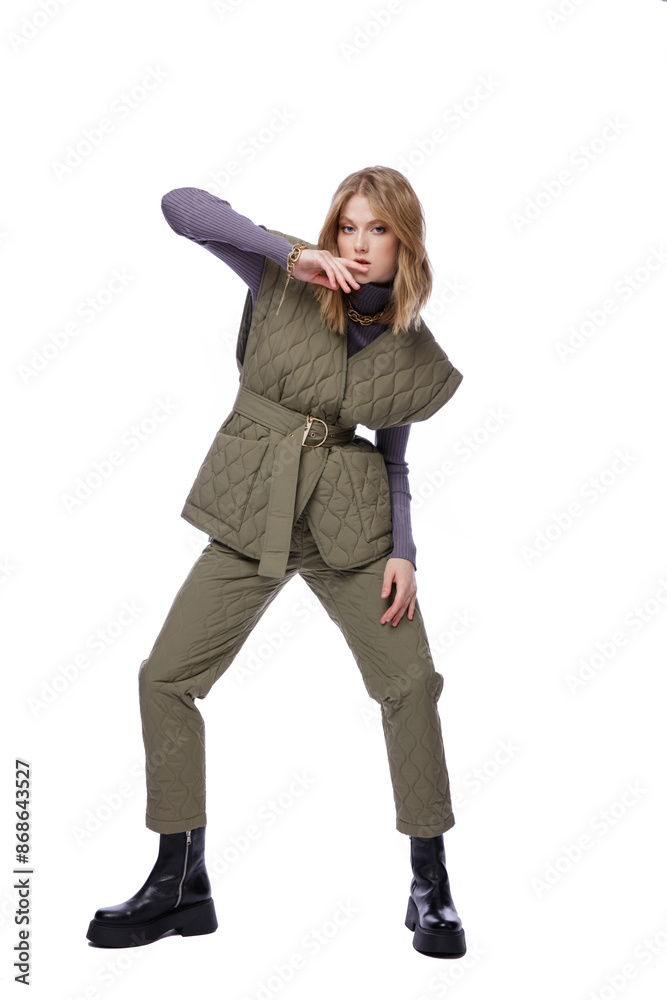 High fashion photo of a beautiful elegant young woman in pretty green pants, trousers, purple blouse, jacket posing on white background. Slim figure. Blonde High fashion photo of a beautiful elegant young woman in pretty green pants, trousers, purple blouse, jacket posing on white background. Slim figure. Blonde