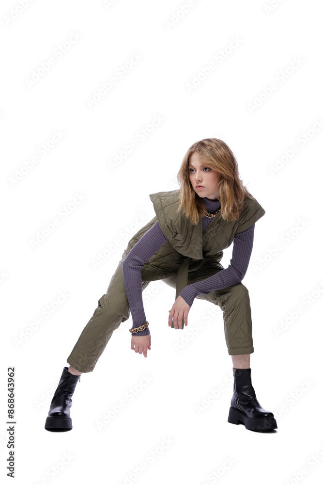 High fashion photo of a beautiful elegant young woman in pretty green pants, trousers, purple blouse, jacket posing on white background. Slim figure. Blonde High fashion photo of a beautiful elegant young woman in pretty green pants, trousers, purple blouse, jacket posing on white background. Slim figure. Blonde