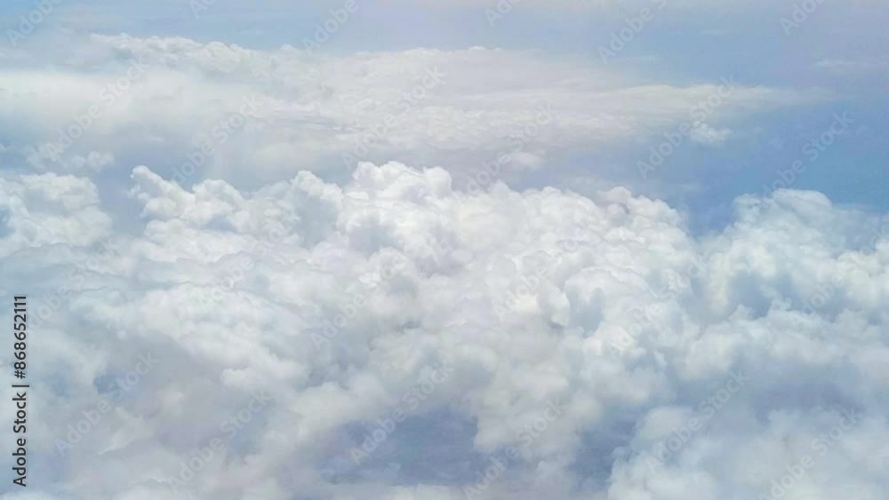 Puffy white clouds moving beneath across the sky, aerial view Puffy white clouds moving beneath across the sky, aerial view