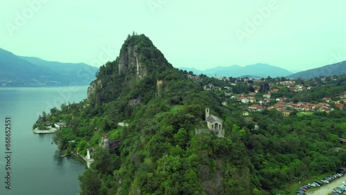 Aerial footage of Rocca of Calde and Lake Maggiore in a summer day - small town of CastelVeccana, Varese, Italy. Lake Maggiore is one of the most important lake in northern Italy 1 photo