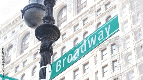 Broadway street road sign, Manhattan midtown district architecture, New York City corner. Traffic signage. Flatiron Building near Madison Square Park. Crossroad of 23 street, Bway and 5 Fifth avenue.