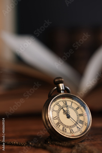 Pocket clock with chain on table, closeup