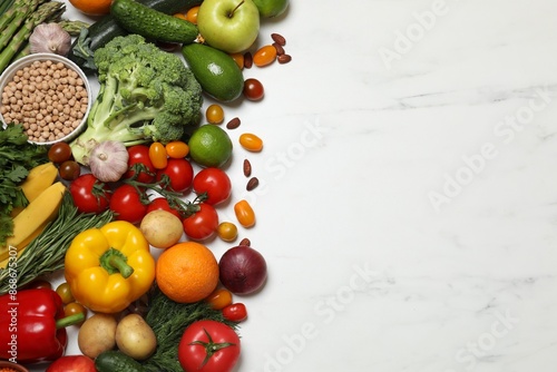 Fototapeta Naklejka Na Ścianę i Meble -  Source of protein for vegetarians. Different fresh vegetables, fruits and herbs on white marble table, space for text