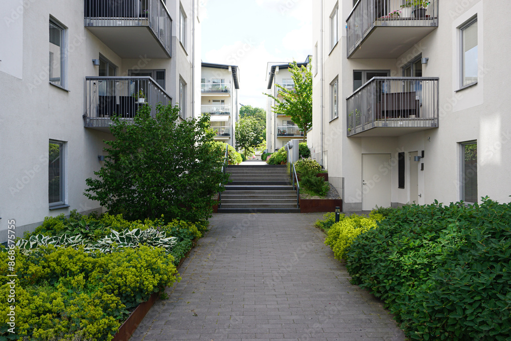 Fototapeta premium A path between buildings during summer