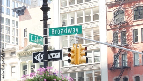 Broadway street road sign, Manhattan midtown architecture, New York City corner. Yellow traffic light. Flatiron district near Madison Square Park. Crossroad of 23 st., Bway and 5 Fifth avenue. One way