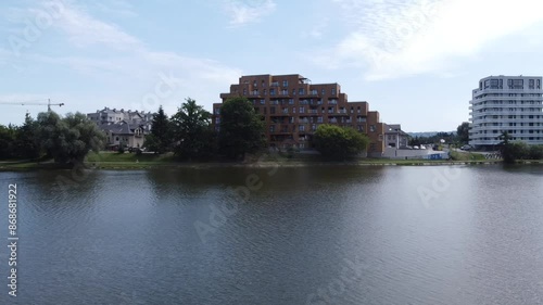 Citycsape of modern building close to city river  on sunny day photo