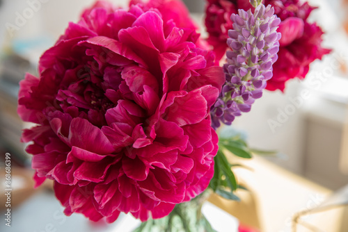 Fototapeta Naklejka Na Ścianę i Meble -  Large red peonies in a vase on the table at home