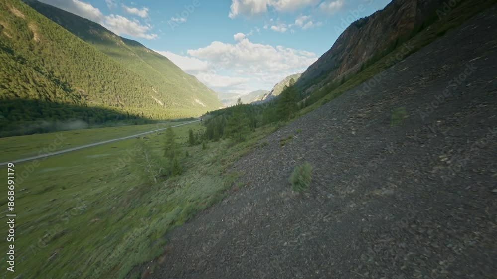 FPV sports drone extreme flight high cliff rocky texture over speed movement natural mountain river water flow narrow gorge. Aerial view nature cascade stream canyon with spruce forest evergreen trees FPV sports drone extreme flight high cliff rocky texture over speed movement natural mountain river water flow narrow gorge. Aerial view nature cascade stream canyon with spruce forest evergreen trees
