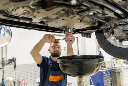 old car oil drained from the engine for a new oil change at a service center or oil change shop