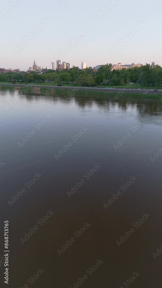 aerial flyover over the Vistula river and view of the city of Warsaw at sunset
aerial flyover over the Vistula river and view of the city of Warsaw at sunset