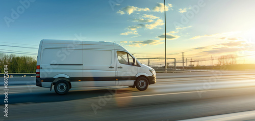 White modern delivery small shipment cargo courier van moving fast on motorway road to city urban suburb. Business distribution and logistics express service. Mini bus driving on highway on sunny day